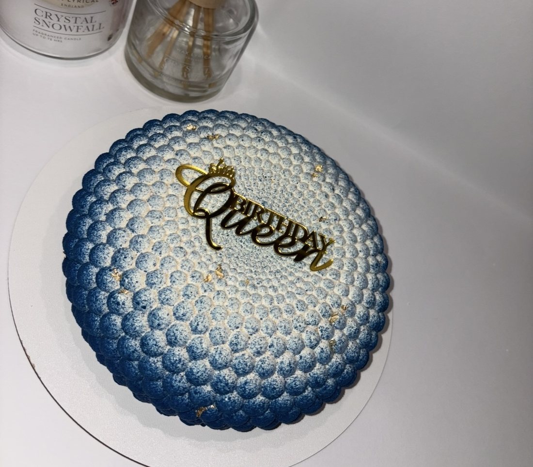 Blue ombre bubble textured mousse cake with a Birthday Queen topper