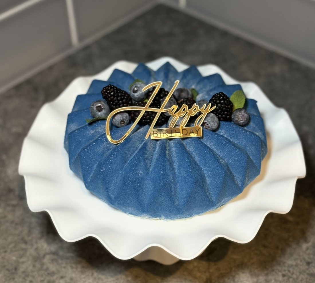 Blue pleated mousse cake with blackberries and blueberries