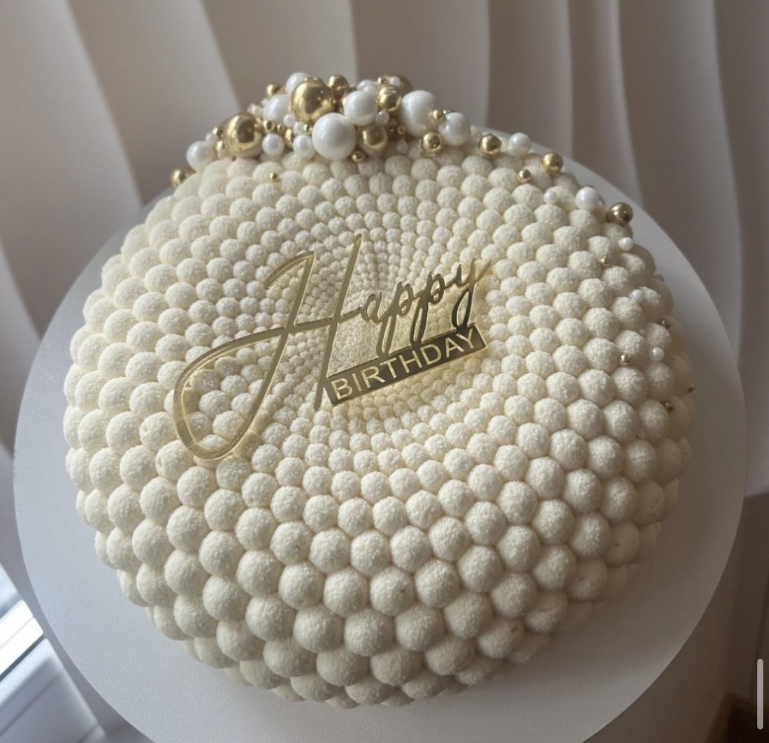 Cream bubble textured mousse cake with pearls and gold spheres