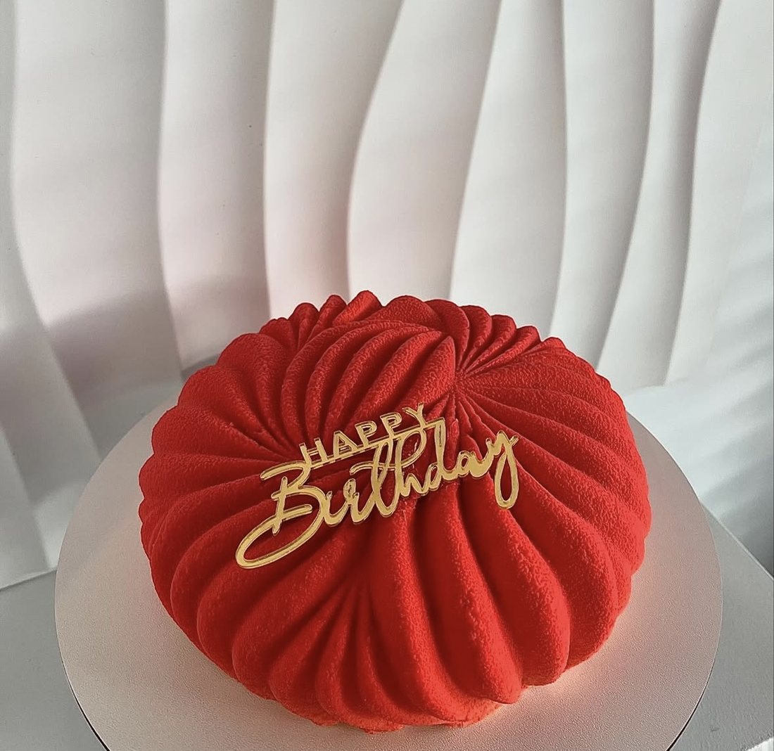 Red pleated mousse cake with a gold Happy Birthday topper