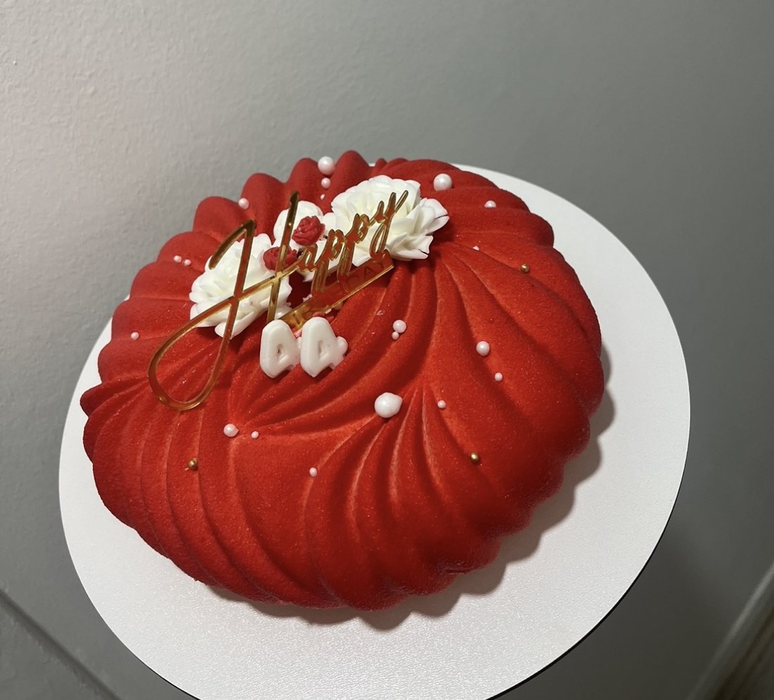 Red pleated mousse cake with white roses for a 44th birthday