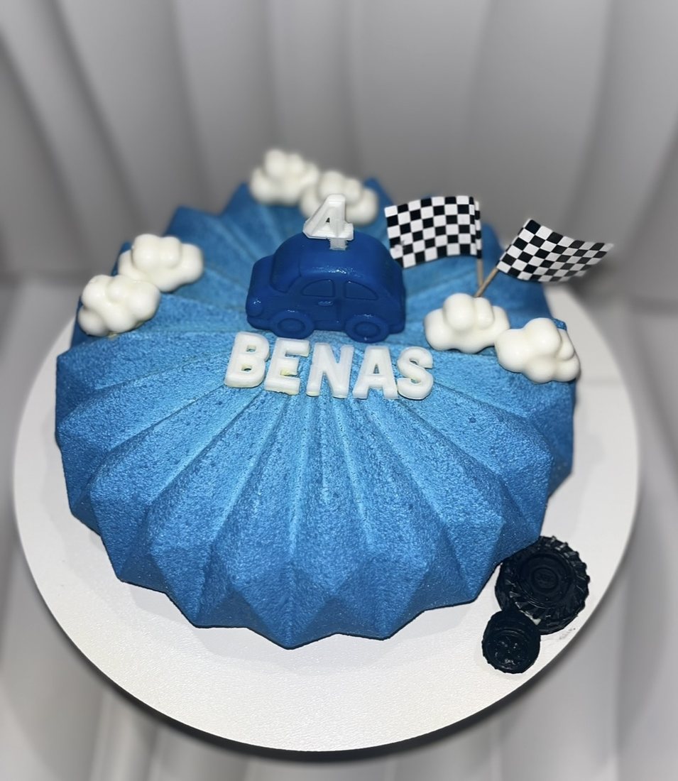 Blue race car themed birthday cake for a 4th birthday