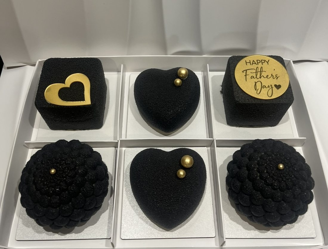 Set of six black and gold Father's Day mousse cakes